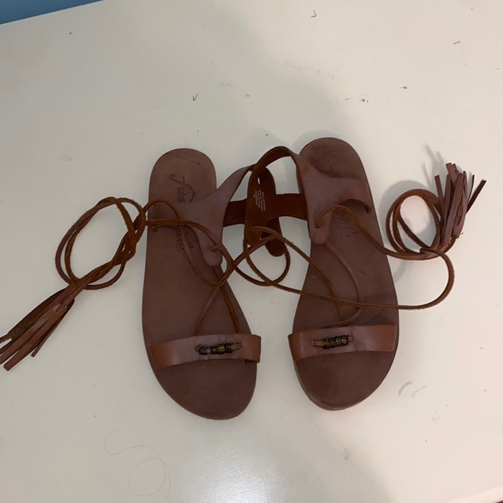 Brown leather wrap gladiator sandals with a tassel